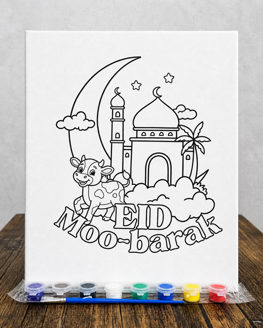 Coloring sheet with a mosque, cow, and 'Eid Mubarak' text on a wooden surface with watercolor pens.