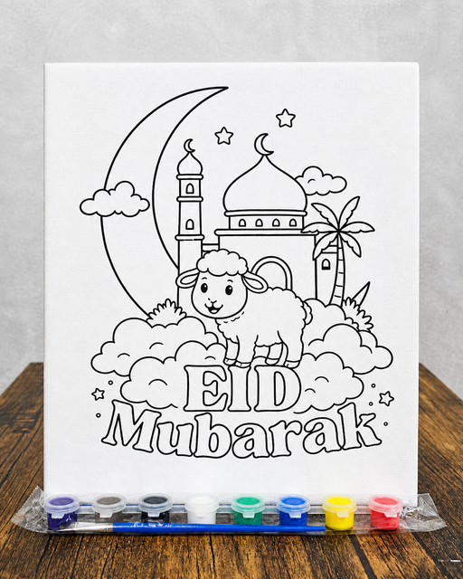 Coloring book page with Eid Mubarak design and watercolor pens on a wooden surface.