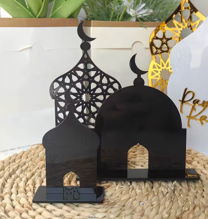 Black decorative arches with crescent moon design on a woven surface.