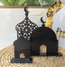Black decorative arches with crescent moon design on a woven surface.