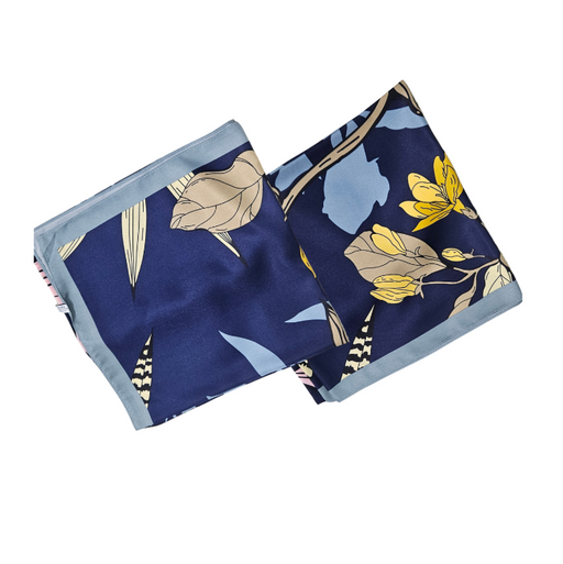 Two floral-patterned square silk scarves on a white background